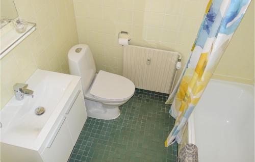 a bathroom with a toilet and a sink and a shower at Cozy Apartment In Aakirkeby in Åkirkeby