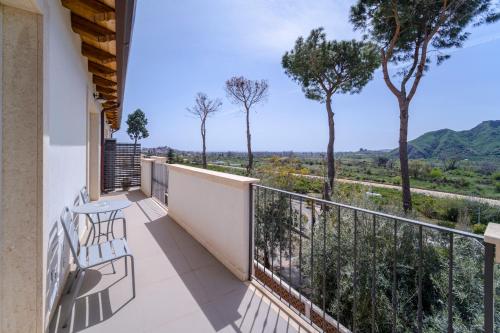 a balcony with a table and chairs and a view at Don Vittorio Country Village in Taormina