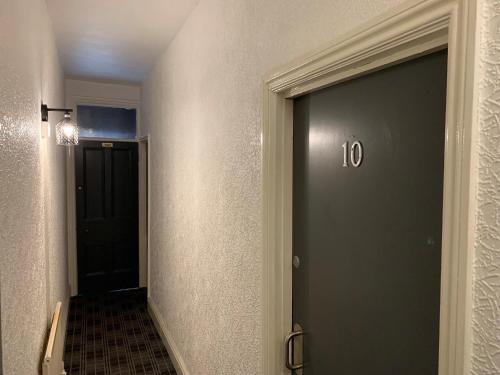 Un pasillo con una puerta con el número. en Urban Inn, en Blackpool
