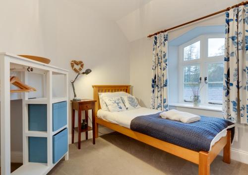 a bedroom with a bed and a window at 2 Railway Cottages in Selside