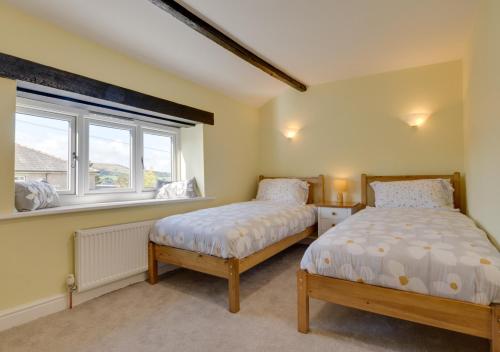 a bedroom with two beds and a window at 3 Ivy Terrace in Bradley