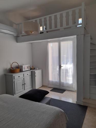 a bedroom with a bed and a sliding glass door at Chambre indépendante in Avignon