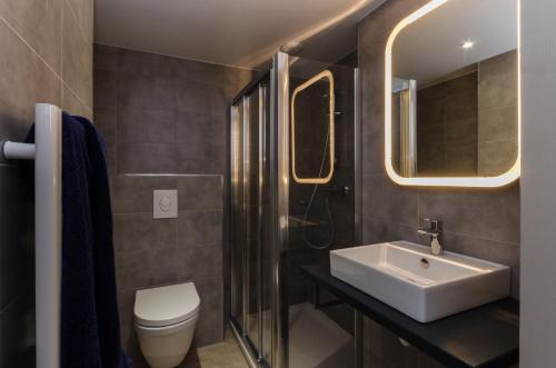 a bathroom with a sink and a toilet at Chalets Residence Snoweden in Montchavin
