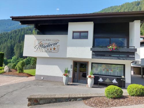 a building with a sign that reads madera at Apart Alpenpension Maderer in Gaschurn