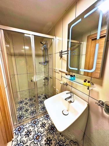 a bathroom with a sink and a shower at Fizzio Alaçatı Hotel in Alaçatı