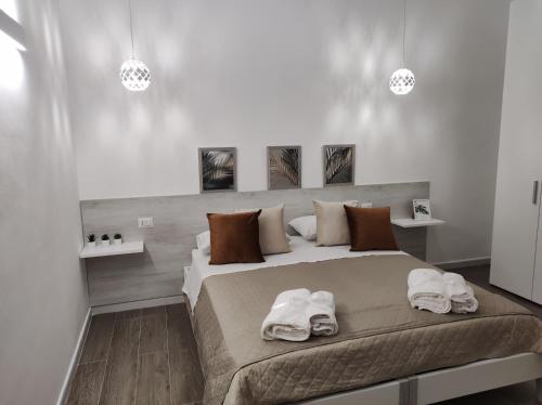 a bedroom with a large bed with towels on it at Kitros in Palagiano
