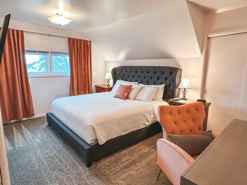 a bedroom with a large bed and a chair at The Manse in Whitefish