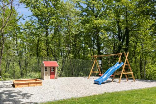 a playground with a slide and a swing set at VILLA PORTUM - Serenity, Nature, Heated Pool, FAMILY ONLY in VeliGolji