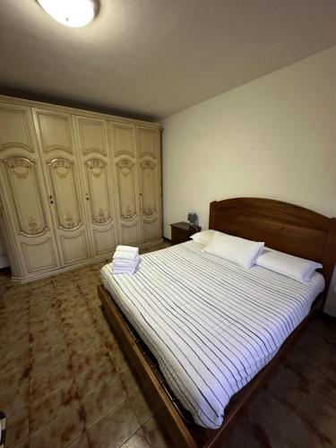 a bedroom with a large bed with two pillows at Coral Apartment in Nettuno