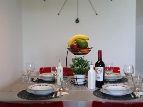 a table with plates and bottles of wine and glasses at Apartment Rodela in Opatija
