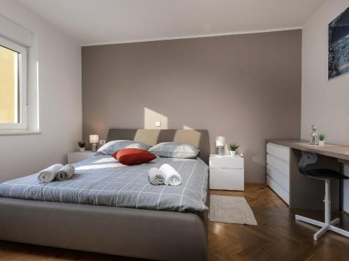 a bedroom with a bed with two towels on it at Apartment Rodela in Opatija
