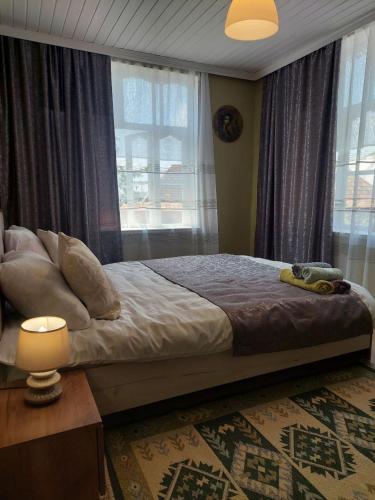 a bedroom with a large bed and a window at Guest House Ruh Achari in Sheki