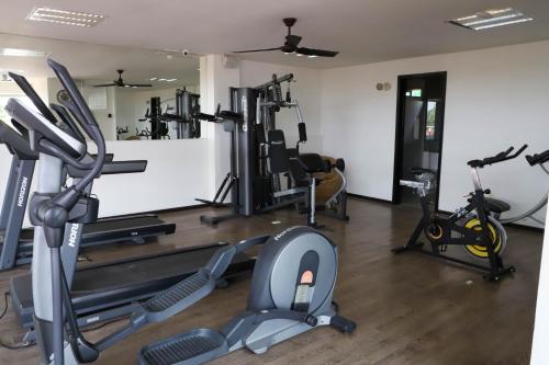 a gym with several treadmills and exercise bikes at Capital Luxury Apartments & Offices in Mexico City