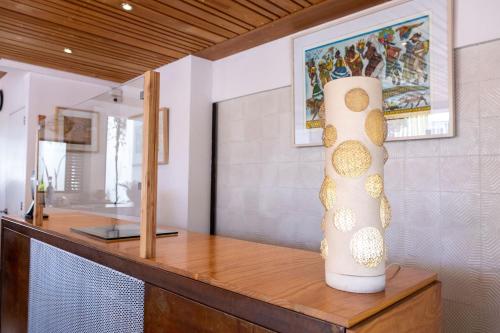a vase sitting on a wooden counter in a room at Casa los Cantaros Hotel Boutique in Oaxaca City