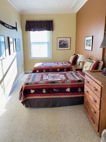 a bedroom with two beds and a window at Bristol Suites in Bristol