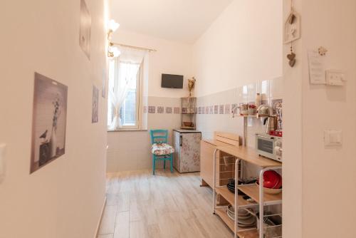 a small kitchen with a counter and a refrigerator at il vicolo delle scuole pie in Città della Pieve