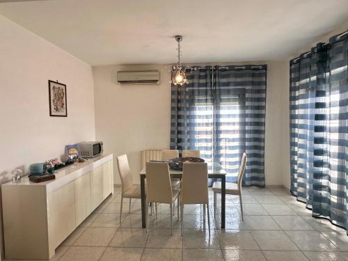 a kitchen and dining room with a table and chairs at Aussie Dream House in Formia