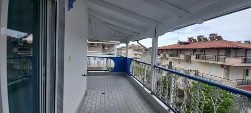 a balcony with a view of a building at Fotini's Beach in Olympiaki Akti