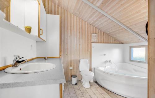 a bathroom with a tub and a toilet and a sink at 3 Bedroom Gorgeous Home In Fan in Fanø