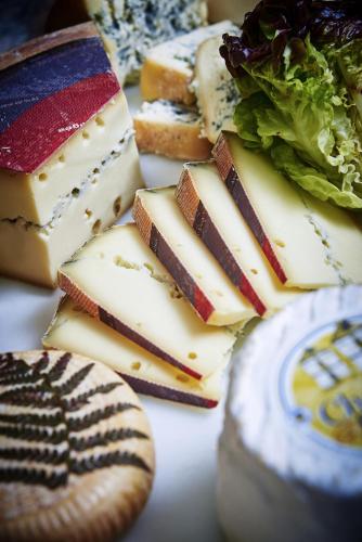 a group of cheeses and bread on a table at Logis Bagatelle - 51530 Dizy in Épernay