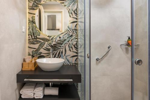 a bathroom with a sink and a mirror at Hermes Sea View in Stalos