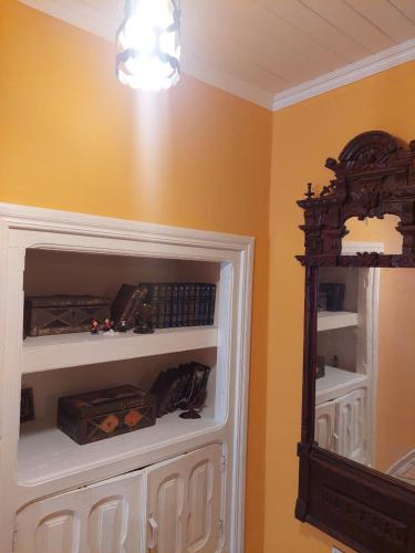 a room with a white cabinet and a mirror at Guest House Ruh Achari in Sheki