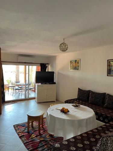 a living room with a couch and a table at Les Hortensias in Bine el Ouidane