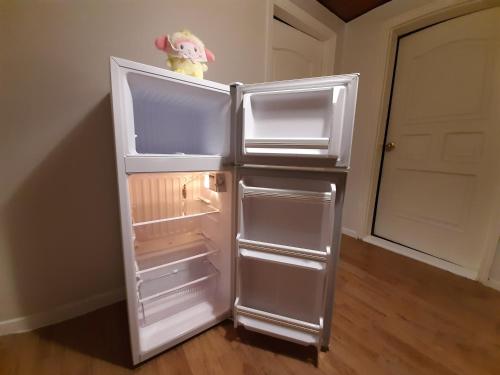 an empty refrigerator with its door open in a room at TY guesthouse room 101 in Seoul
