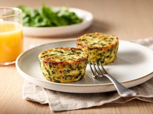 a plate with two muffins on a table with a fork at TownePlace Suites Fort Worth University Area/Medical Center in Fort Worth