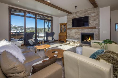 a living room with a couch and a fireplace at Mountain Lake Condo - Unit 502B in Big Sky