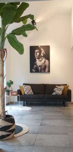 a living room with a couch and a tree at Landhuys Odette in Retie
