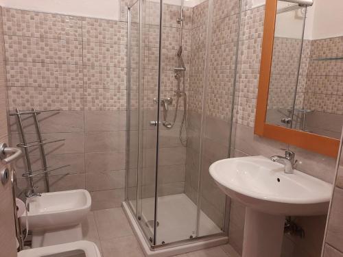 a bathroom with a shower and a toilet and a sink at ARC BLEu in Siniscola