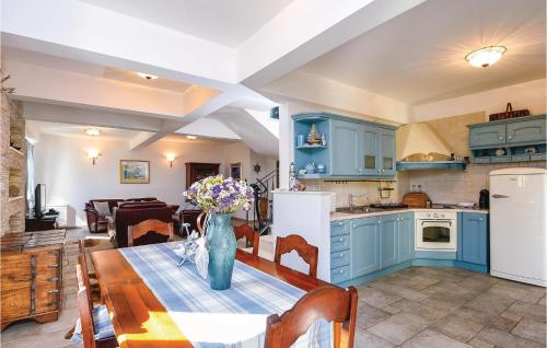 a kitchen with a table with a vase of flowers on it at Stunning Home In Klek With Sauna in Klek