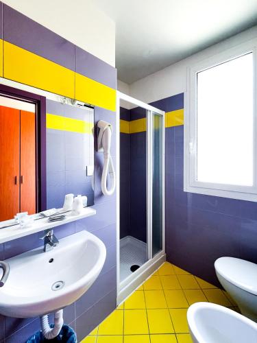 a bathroom with a sink and a shower at Hotel Morfeo - Fun Hotel - NO FAMILY in Rimini