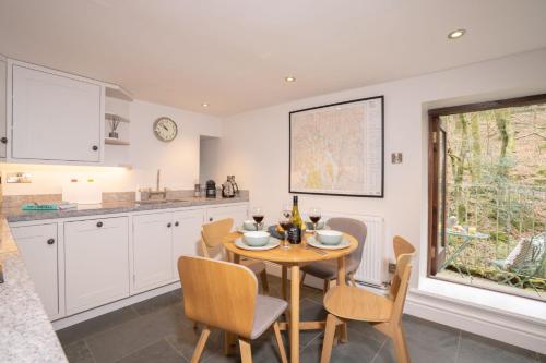 a kitchen with a table and chairs and a window at Spacious Property with Waterfall View by LetMeStay in Ambleside