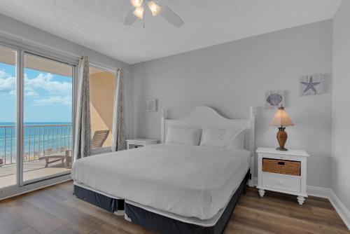 una camera con letto e un balcone con vista sull'oceano di Treasure Island 0207 a Panama City Beach