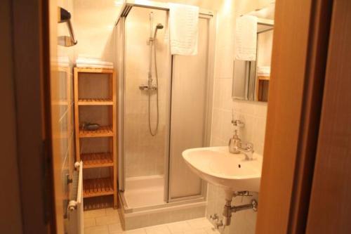 a bathroom with a shower and a sink at Rosenhof in Ebensee