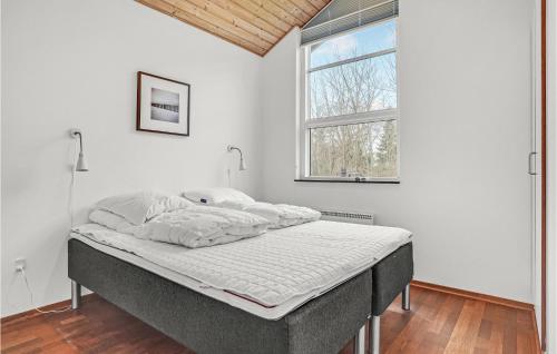 a bed in a white room with a window at Stunning Home In Allingbro With 3 Bedrooms And Wifi in Allingåbro