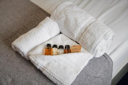 a white wrapped arm on a bed with medicines at Hamlet Hotels Maidstone in Maidstone