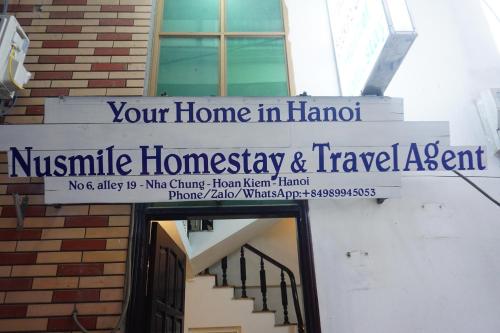 a sign that reads your home in hanoinsic homnsics and travel agent at Nusmile's Hostel and Travel in Hanoi