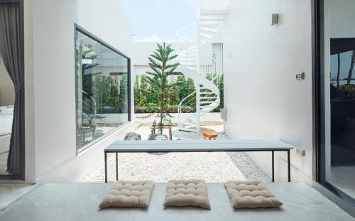 a house with three pillows on the floor at Sea Season Pool Villa Pattaya in Bang Lamung