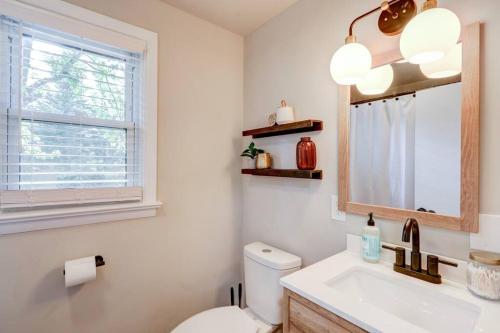 a bathroom with a toilet and a sink and a window at New cozy home near Outlets & Amish Country in Lancaster