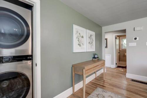 a room with a washing machine and a wooden table at New cozy home near Outlets & Amish Country in Lancaster
