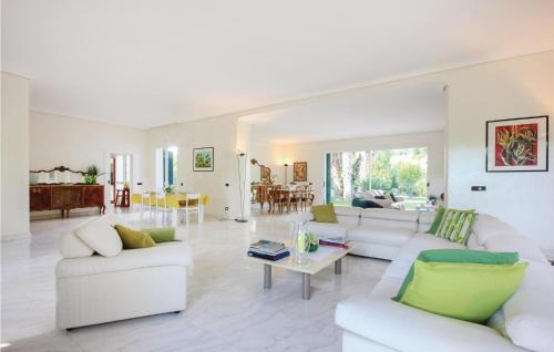 a living room with white couches and a table at Green House in Comiso