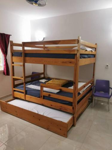 two bunk beds in a room with a blue chair at CasaCanda king size in Somone