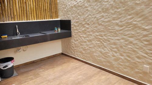 a bathroom with a counter and a sink in a room at Villa Andorinha -Apto01 in Mucugê