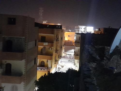a view of a city at night with buildings at Karnak flat in Luxor
