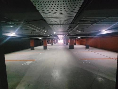 an empty parking garage with lights on the ceiling at Loft aconchegante à Beira-Mar in João Pessoa