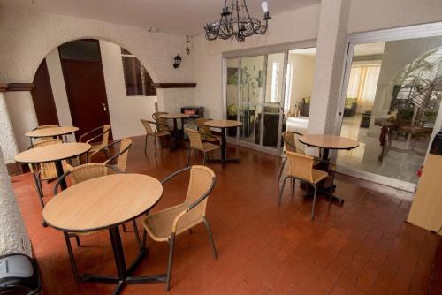 a group of tables and chairs in a room at Nuevo Bamboo in Piura