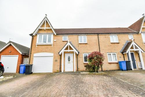 a brick house with white doors and a driveway at Beech Court House By Horizon Stays in Widdrington